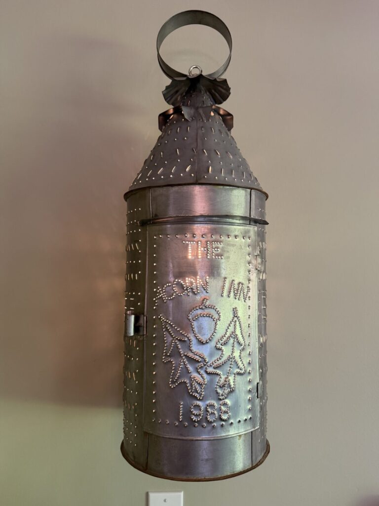 A lantern with a dragon on it is lit up in the dark.