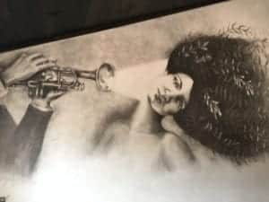 artwork of lady and man blowing trumpet at Hollerhorn Distilling in Naples, just 20 minutes south of the 1795 Acorn Inn