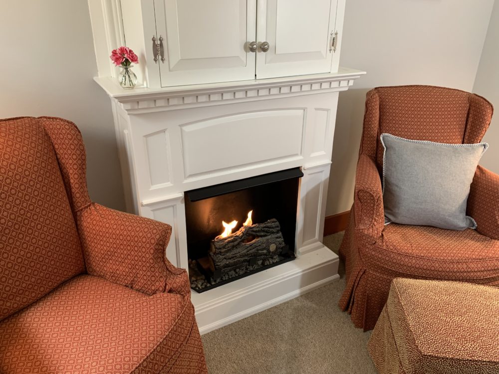 Wilder Room fireplace with 2 chairs for relaxing