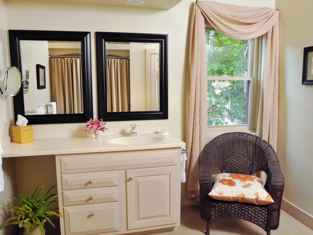 Wilder Room bathroom with vanity and 2 mirrors, wicker chair