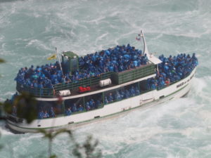 Maid of the Mist boat with people in raincoats at Niagra Falls, NY... about one and a half hours from the 1795 Acorn Inn Bed and Breakfast in Canandaigua