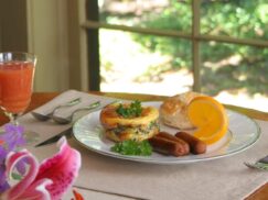 Savory spinach stratta served with sausage and biscuit with the 1795 Acorn Inn B & B's signature cranberry and orange juice
