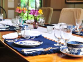 1795 Acorn Inn Finger Lakes Bed and Breakfast table set for breakfast with garden flowers in vases