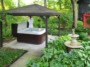 jacuzzi tub and fountain surrounded by shrubbery