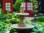 fountain surrounded by shrubbery