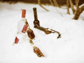 bottles of liquor in chilling in the snow and ready to go