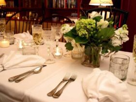 table set for wedding with white flowers, water and wine glasses, silverware and napkins at the 1795 Acorn Inn... the perfect romantic getaway for a intimate wedding