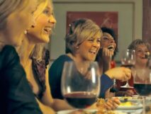 laughing women tasting wine
